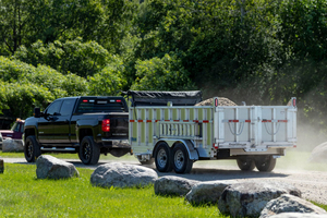 black-truck-pulling-mission-commerical-utility-dump-trailer.jpg